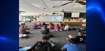 Students watching a zoom meeting with Cosmosphere