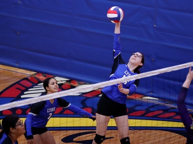 Lyons player spikeing the volleyball